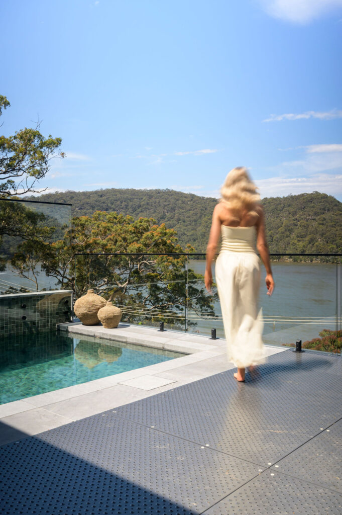 Woman by pool with ocean views