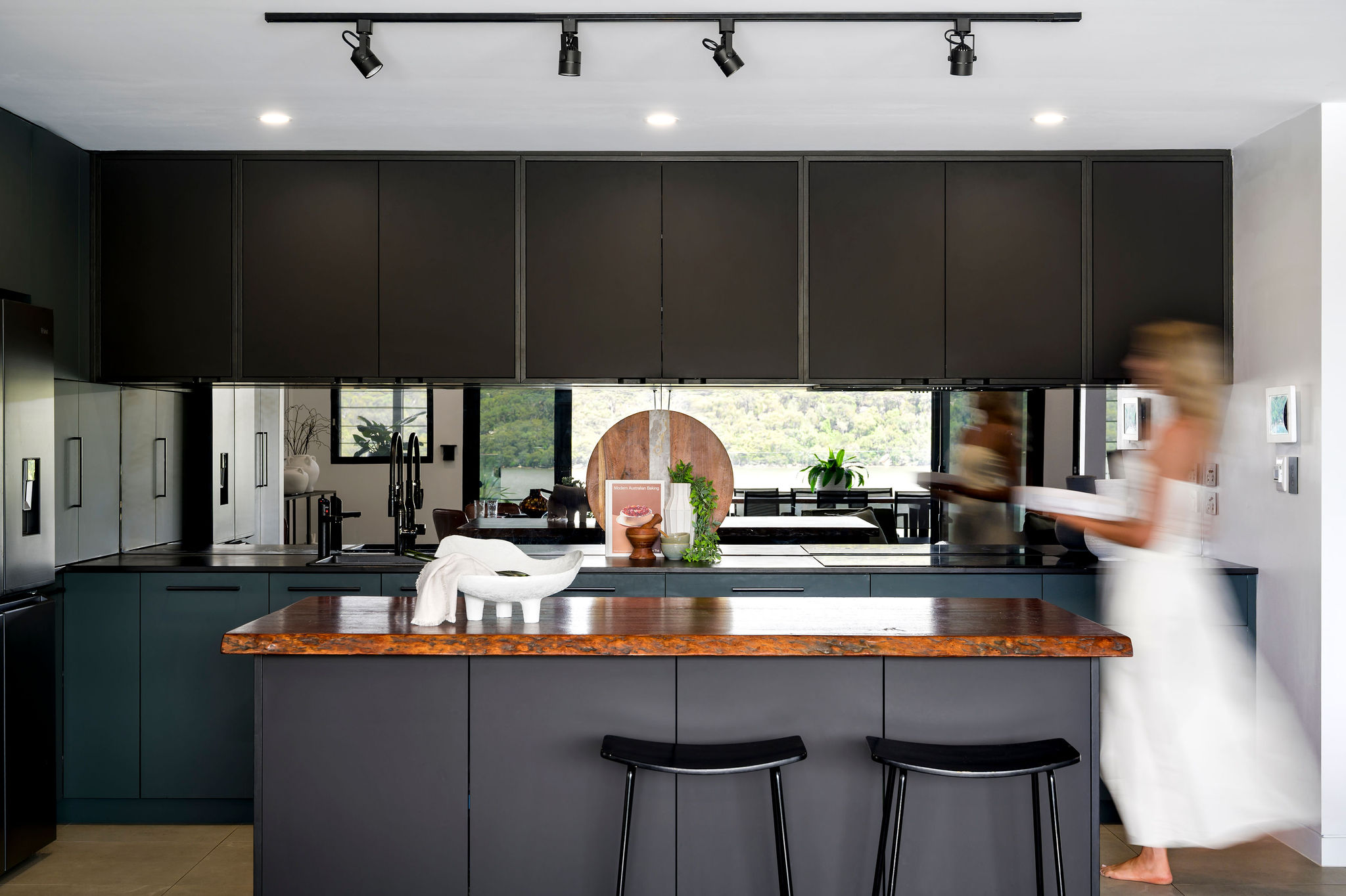 Kitchen with black cabinetry and breakfast bar